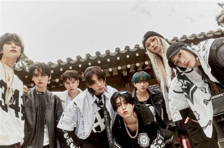 Stray Kids' Felix, Hyunjin and Bang Chan are in front of a set of stairs.